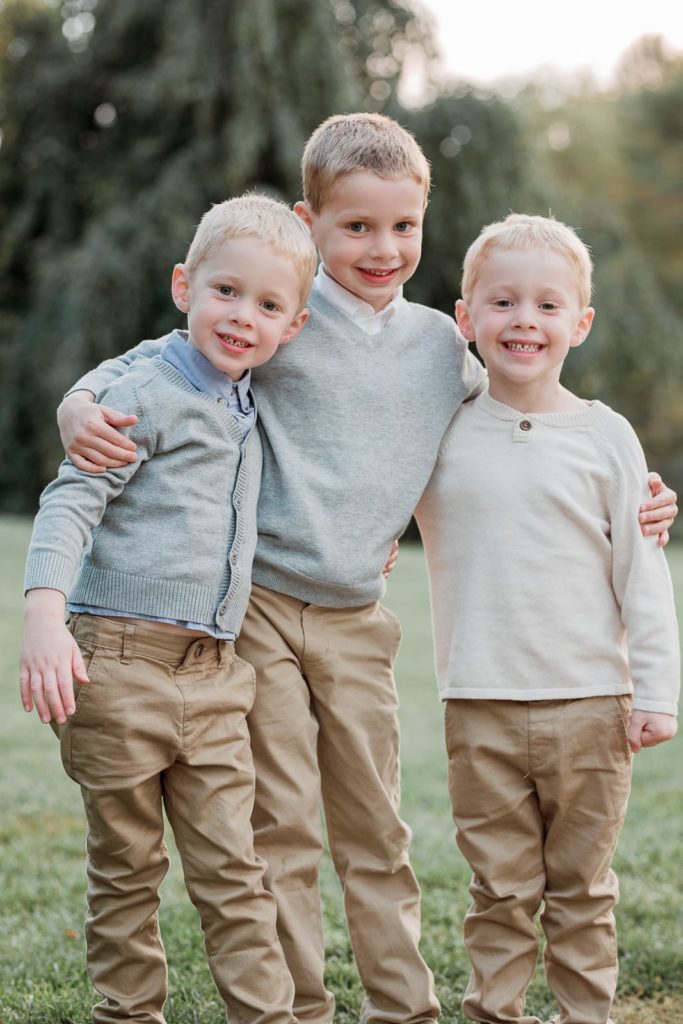 A family of boys! Brothers stand together during family portrait session in Detroit Michigan with professional family portrait photographer laurel smith photography how to get good pictures of your family outfit ideas and family pic inspiration cute smiling kids during family pictures tips for a successful portrait session #detroitfamilypictures #detroitfamilyphotographer #familypictures #familyportraits #familypictureoutfits #familyoutfitinspo