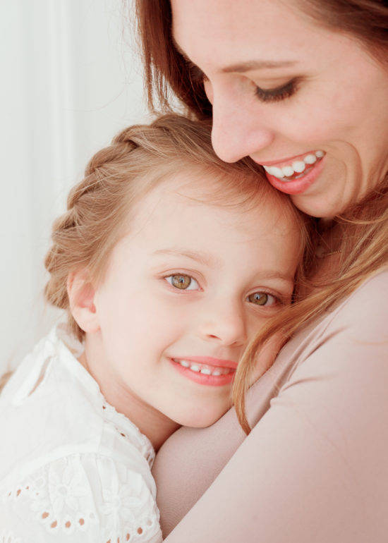 Mother and daughter hugging during photo session with Laurel Smith Photography after discussing the 3 best pediatricians in Ann Arbor, Michigan.