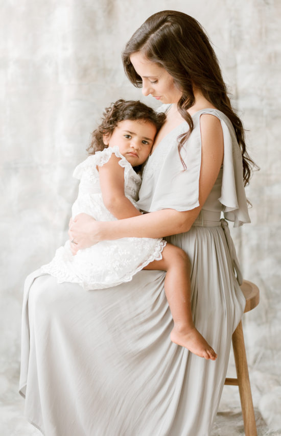Mom holding daughter during Metro-Detroit photo shoot after finding one of the 3 best Detroit hair salons. 
