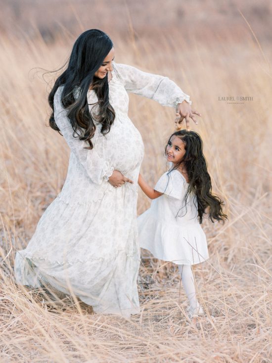Mother dancing with daughter in field after visiting one of the 10 Best Berkeley Pediatricians
