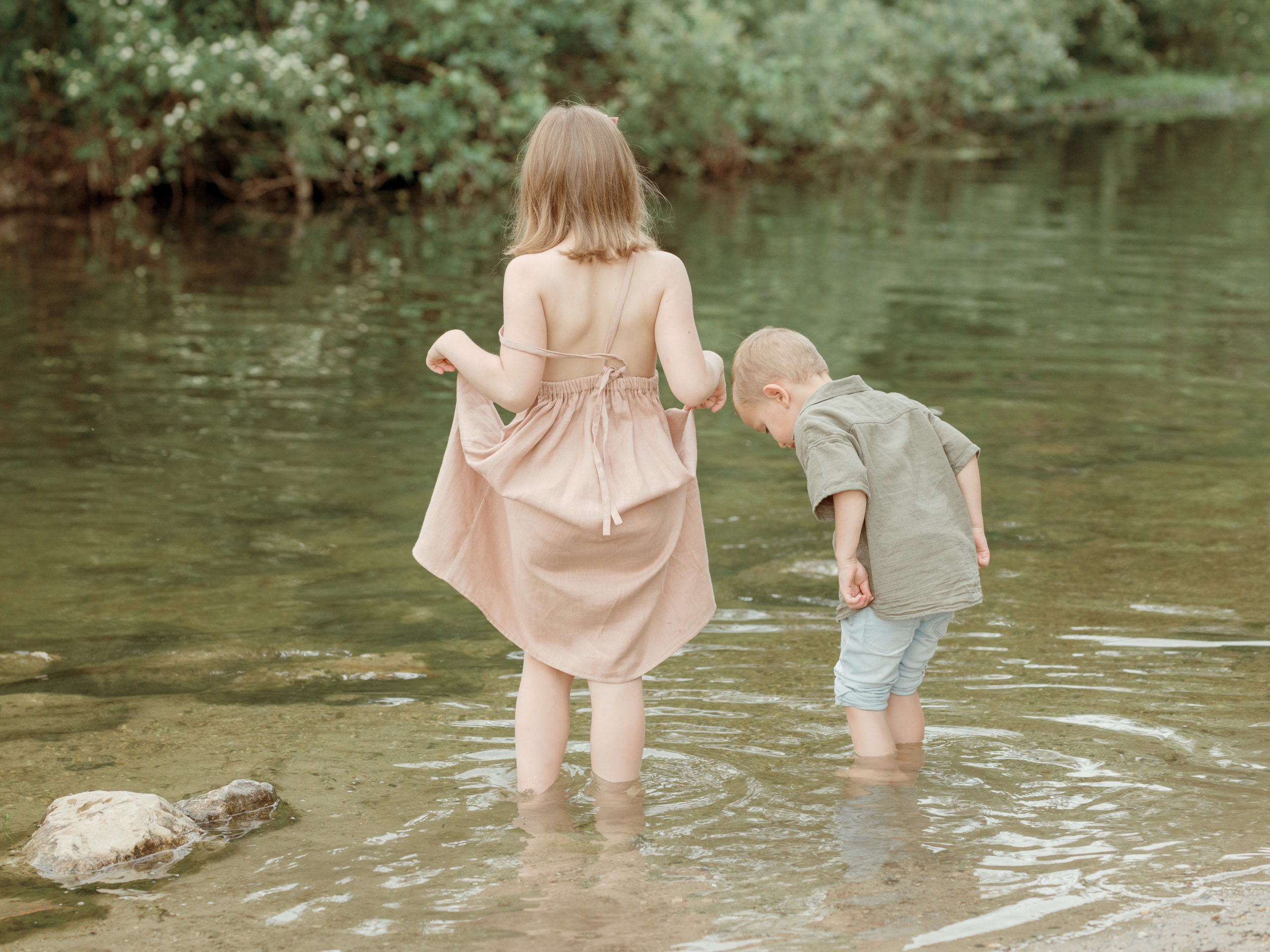 siblings exploring the creek together