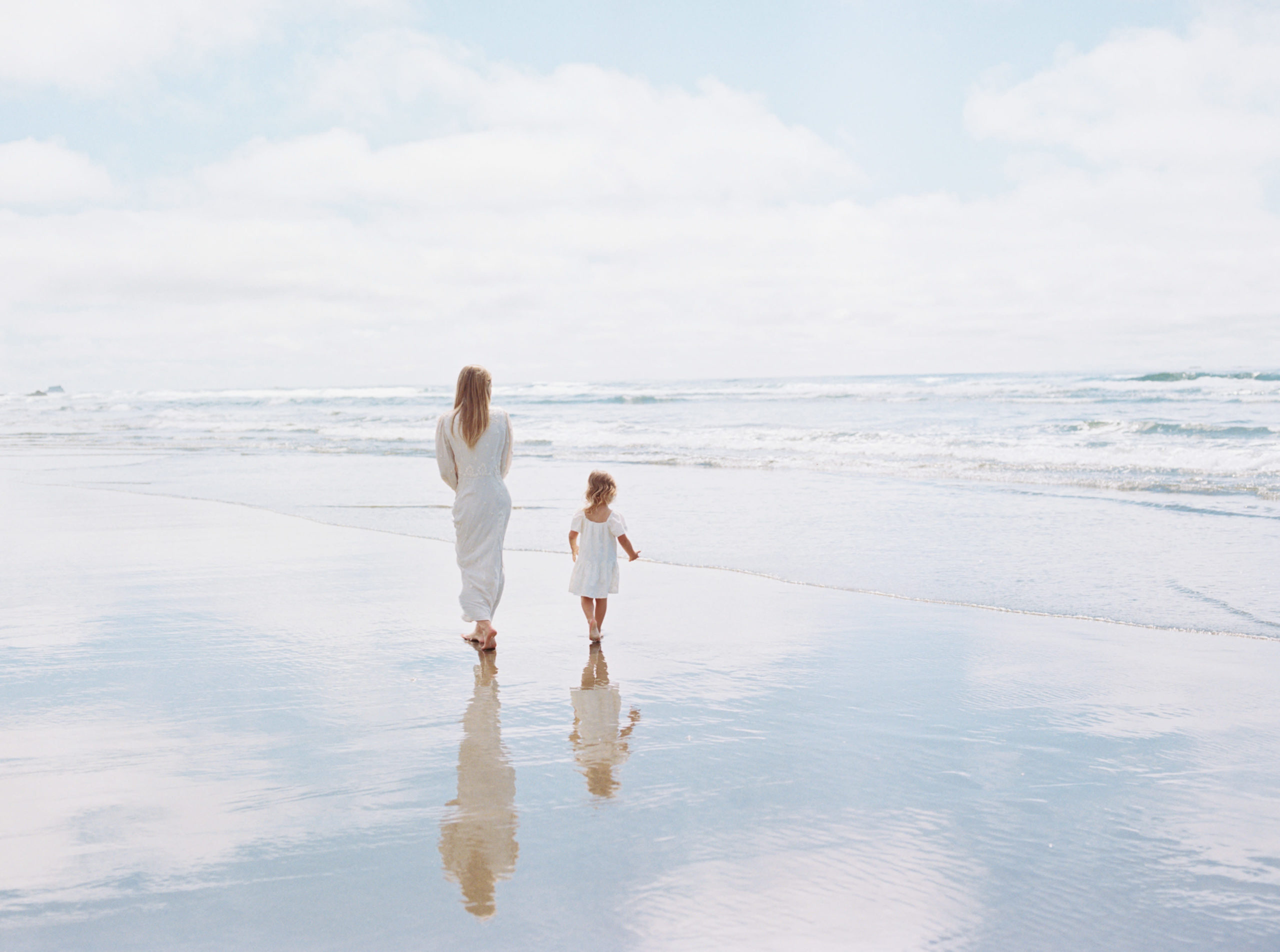 mom walking with her young daughter on the beach Brentwood Pediatricians