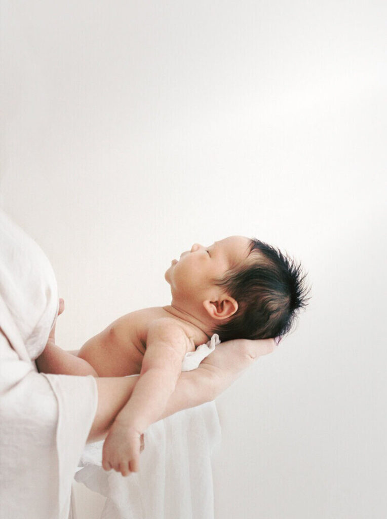 mom holding newborn taken by Brentwood newborn photographer