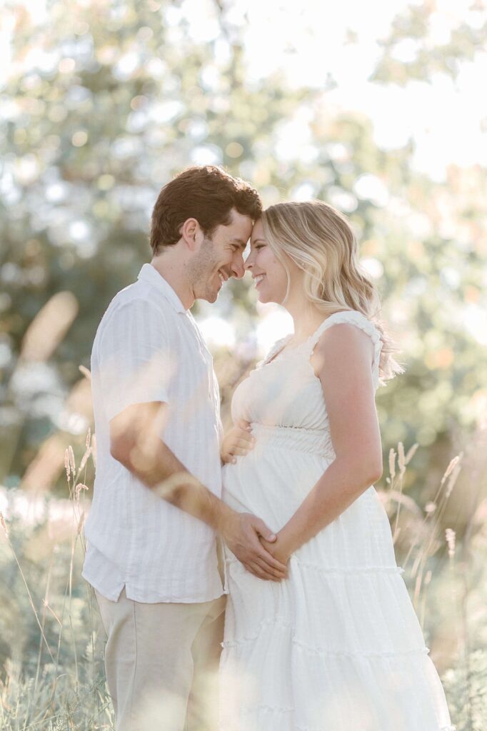 couple dressed in white during their ​maternity couples photos in san francisco taken by laurel smith photography