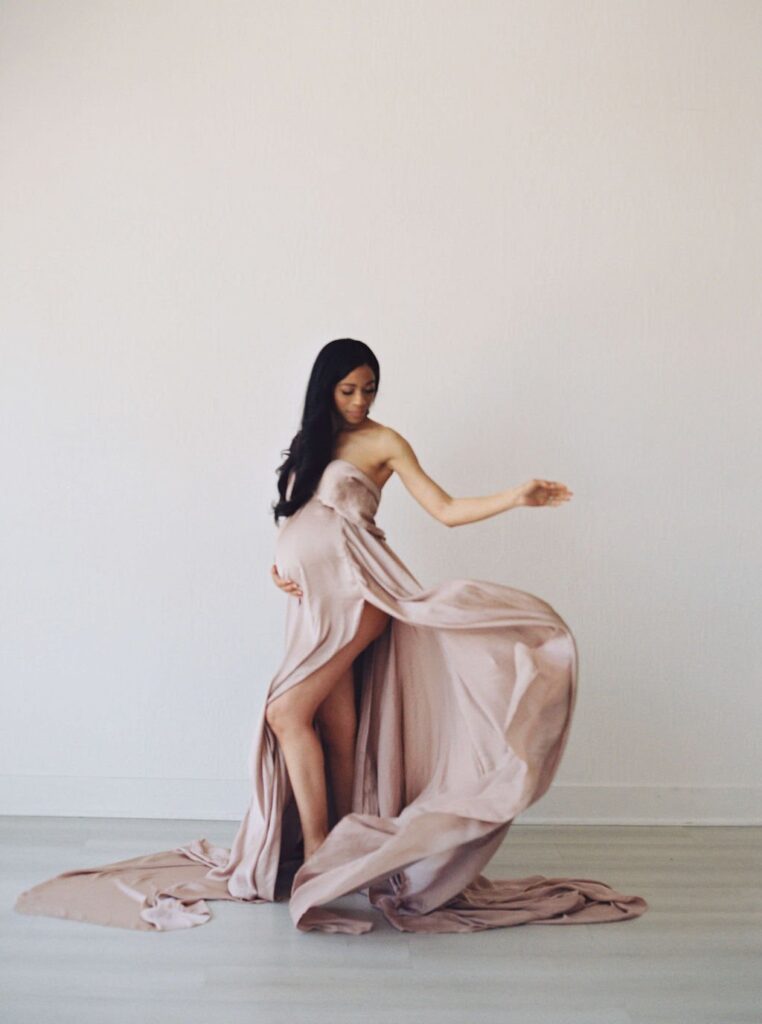 woman in champange flowy dress during her san francisco maternity photos session with laurel smith photography