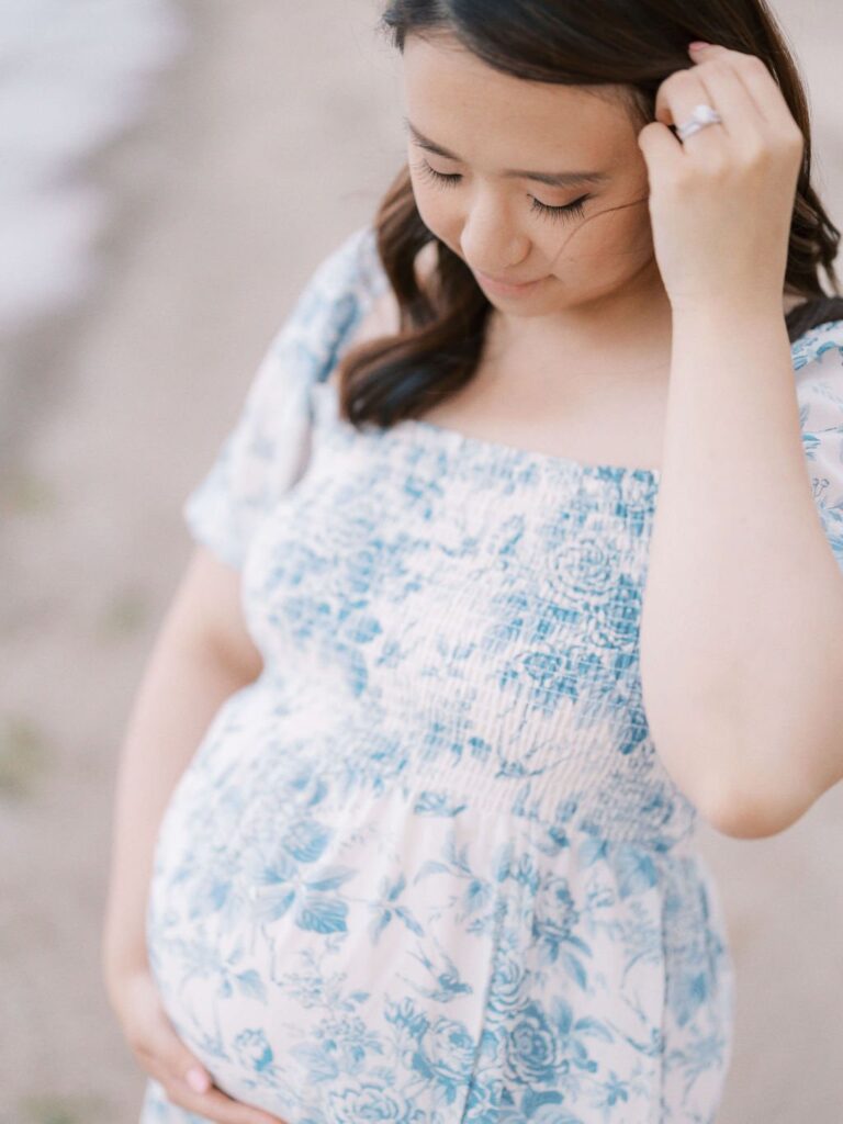 woman in blue dress during session for maternity photos in san francisco beach location with laurel smith photography