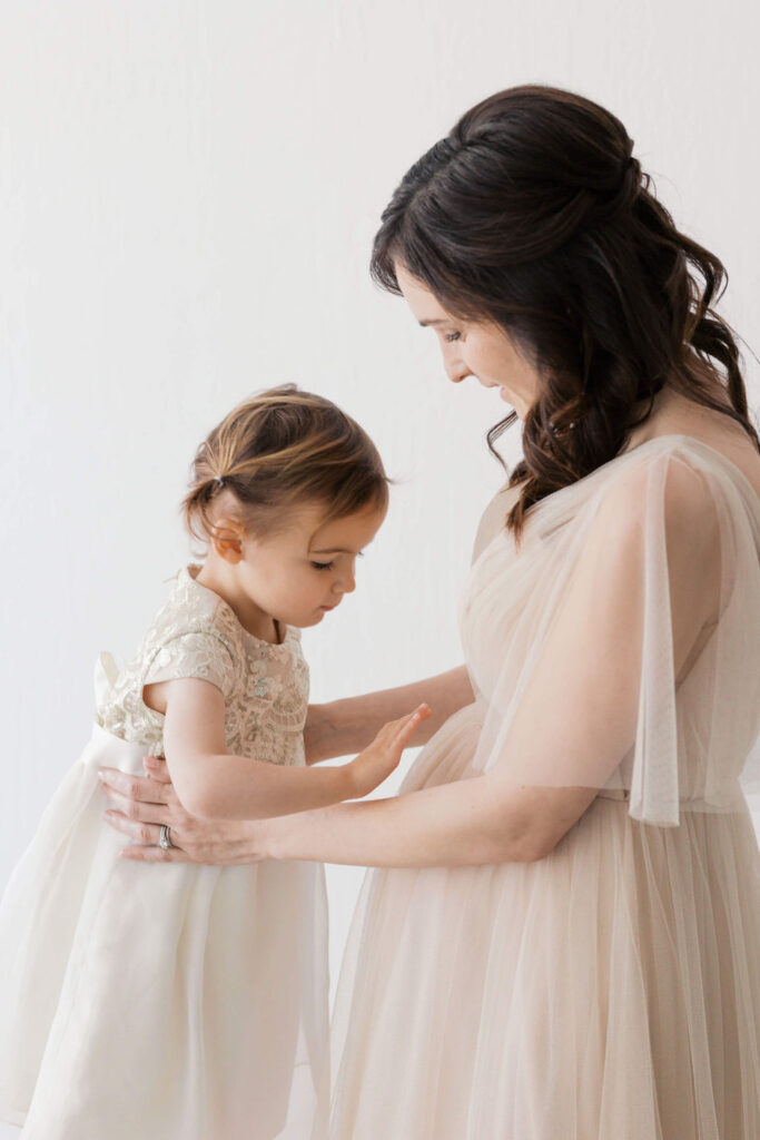 Family maternity photography San Francisco showing mama holding her toddler before shifting into couple portraits.