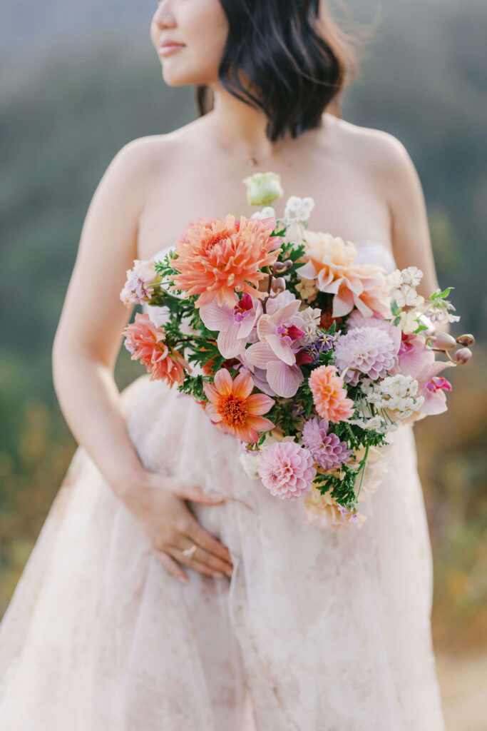 Maternity couple photoshoot San Francisco showing a solo portrait of a mama-to-be holding flowers. 