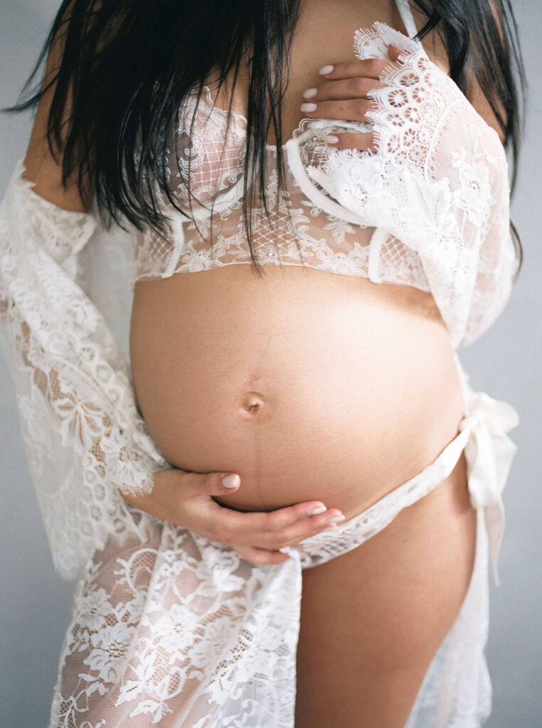 Maternity couples photos San Francisco showing tender connection of mama cradling her belly. 