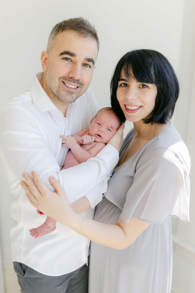 Newborn Photo Studio San Francisco | Laurel Smith Photography Newborn and family photos San Francisco showing parents cuddling newborn.