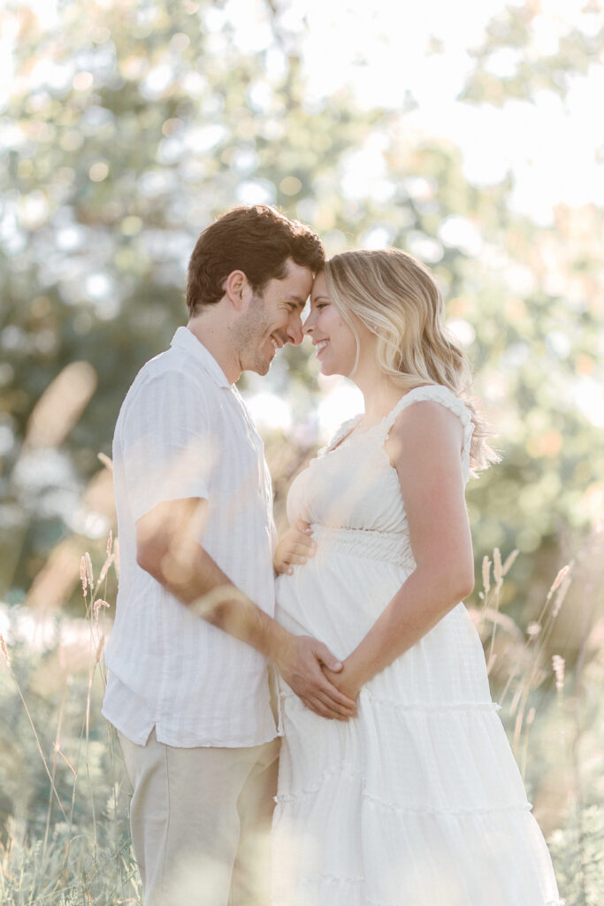 Maternity photo sessions San Francisco with couple embracing outdoors. 