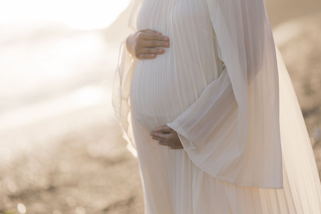 closeup of a pregnancy bump taken at rodeo beach ca by laurel smith photography