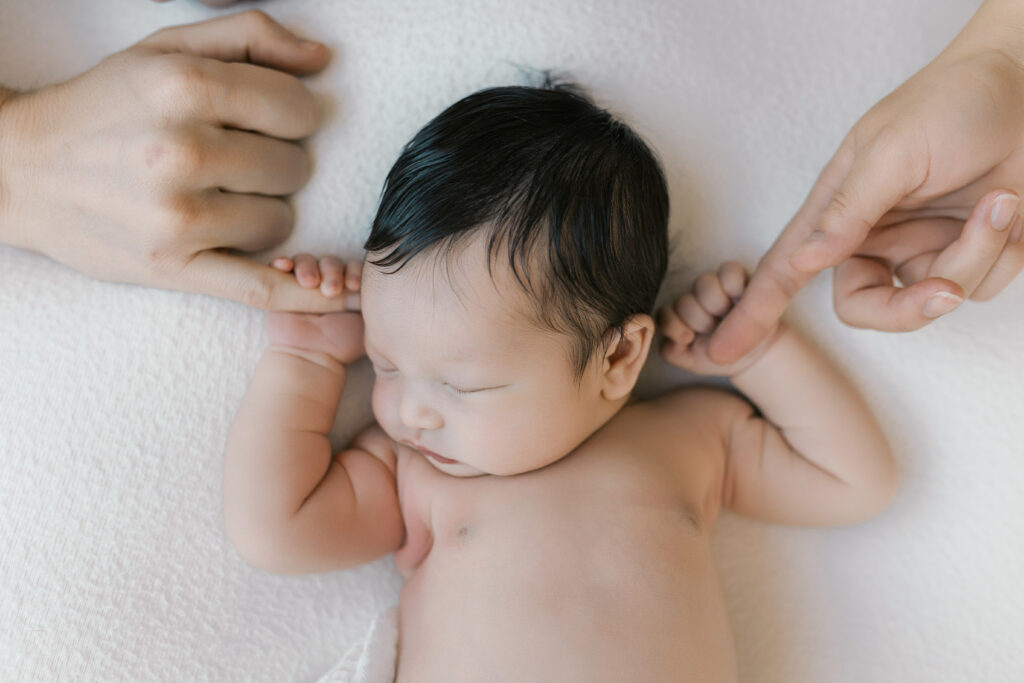 Sleeping newborn baby portrait showing the best time for newborn photos during the first weeks.