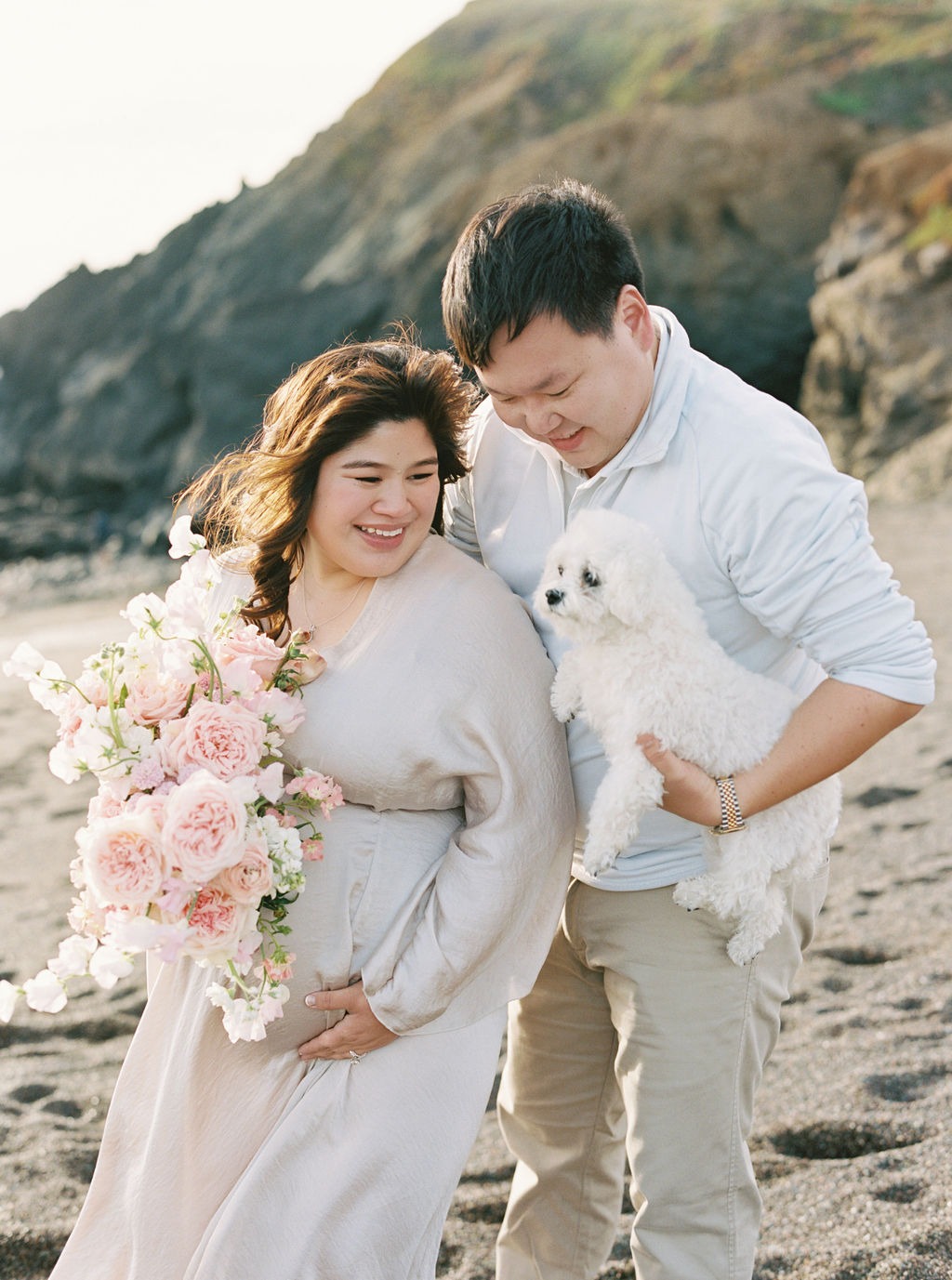 portrait of a woman, a man, and their dog during their maternity photoshoot at one of the best photo locations san francisco