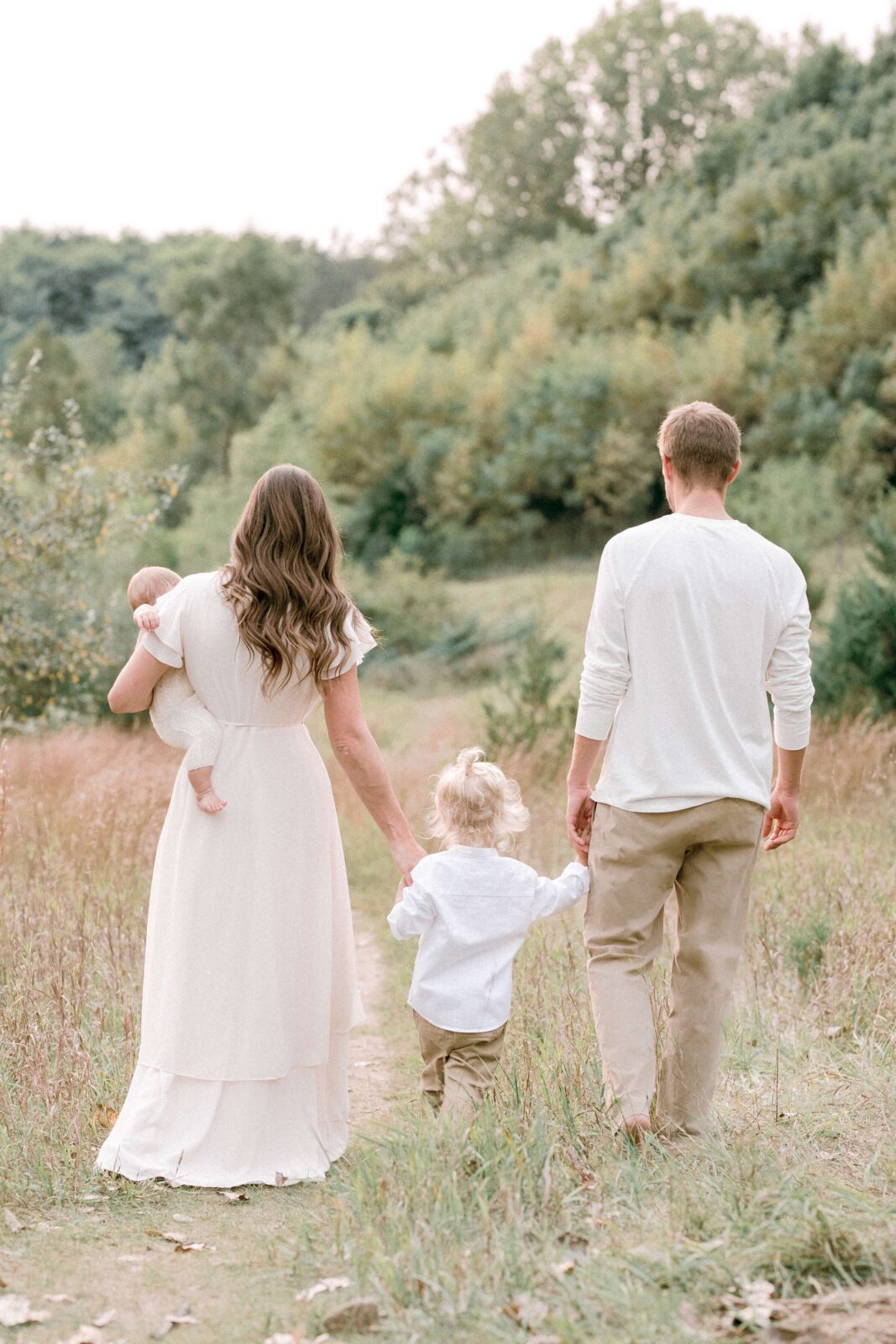 Family with two young children walking together during an outdoor Bay Area photography session
